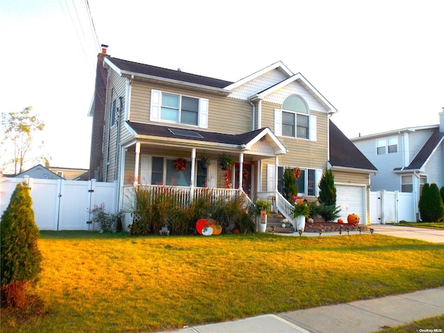 view of front of property featuring a garage and a front lawn