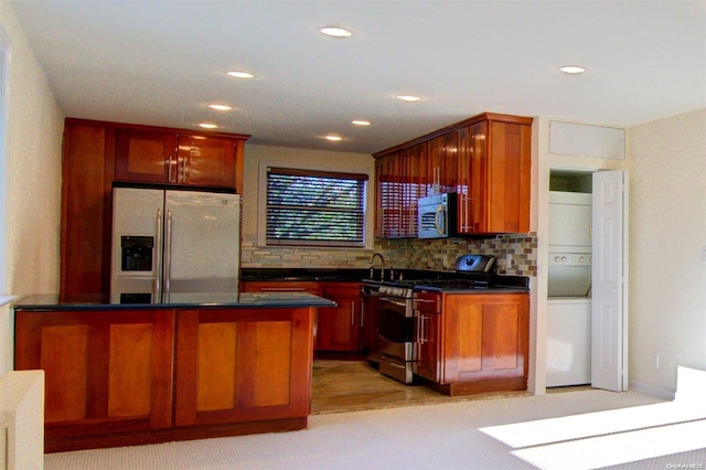 kitchen featuring backsplash, stainless steel appliances, and light carpet