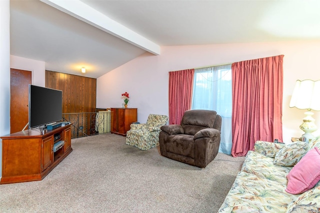 carpeted living room with lofted ceiling with beams and wood walls