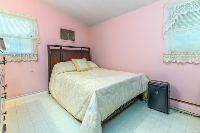 bedroom featuring a baseboard radiator and vaulted ceiling