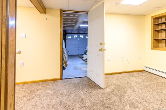 spare room with carpet flooring, a paneled ceiling, and baseboard heating