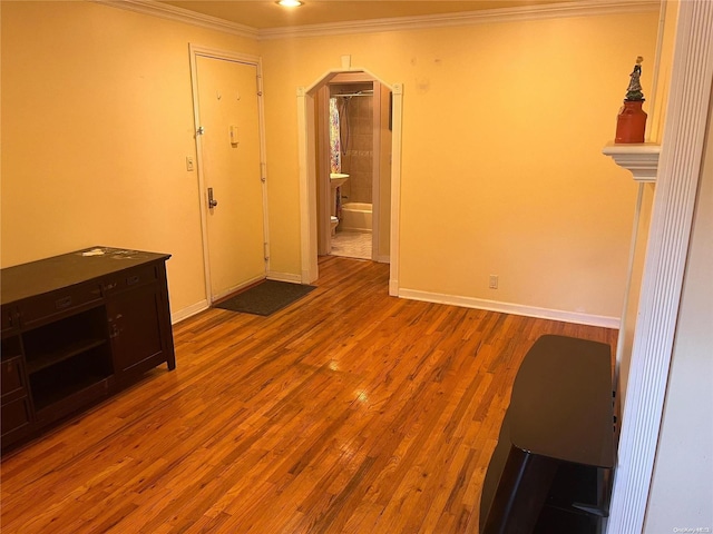 empty room featuring light hardwood / wood-style floors and ornamental molding