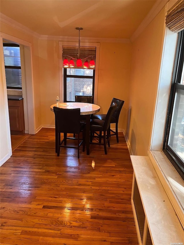 dining space featuring dark hardwood / wood-style flooring and crown molding