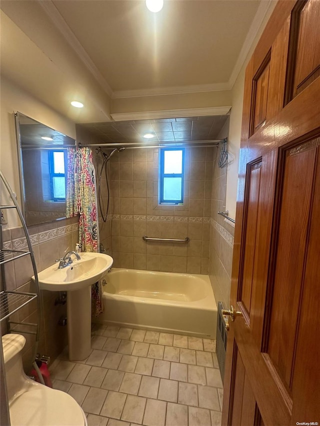 bathroom with crown molding, tile patterned flooring, toilet, tile walls, and shower / tub combo with curtain