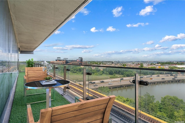 balcony featuring a water view