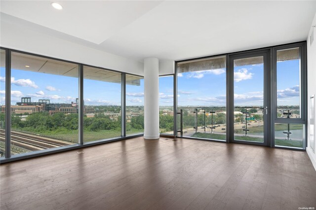 131-05 40th Rd Unit 10J, Flushing, NY 11354 - empty room featuring wood finished floors, recessed lighting, and a wall of windows