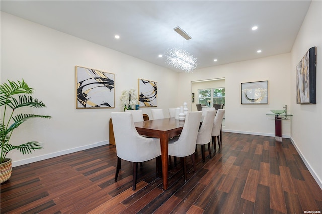 dining space with a chandelier and dark hardwood / wood-style flooring