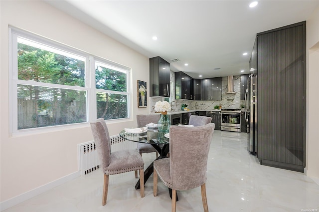 410 Church Ave, Woodmere, NY 11598 - dining area featuring recessed lighting, light marble finish floors, and radiator heating unit