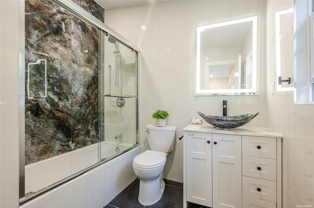 full bathroom featuring vanity, toilet, and enclosed tub / shower combo