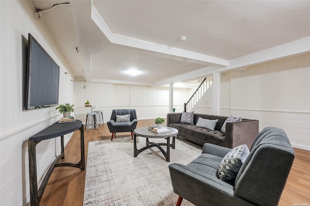 410 Church Ave, Woodmere, NY 11598 - living room featuring wood finished floors, stairs, a decorative wall, and crown molding