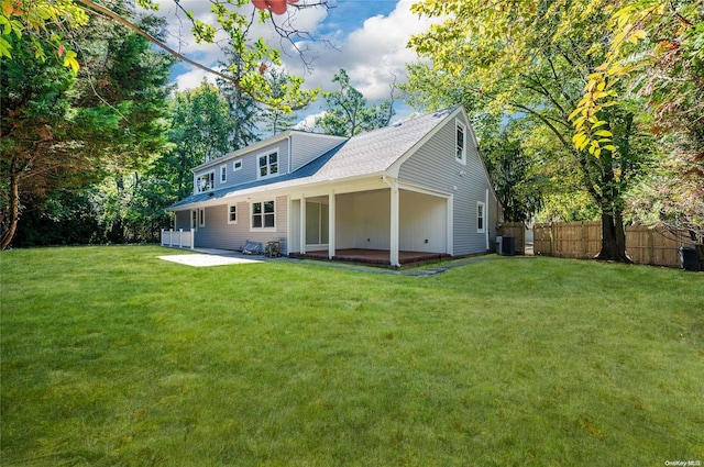 back of house featuring a yard, central AC, and a patio area