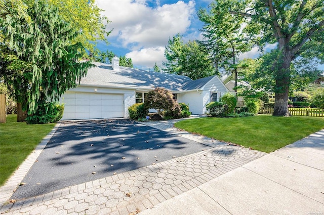 single story home with a front yard and a garage