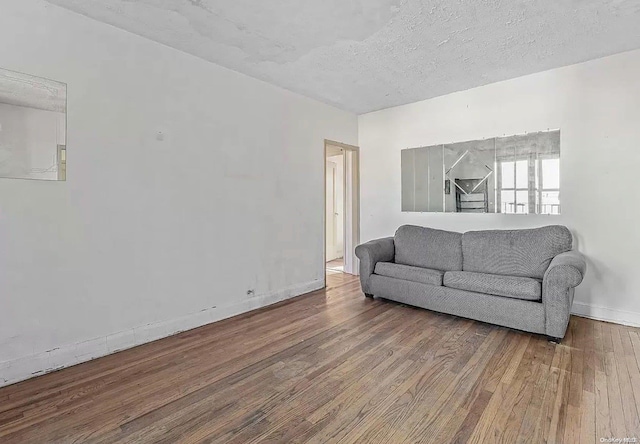 living room with hardwood / wood-style floors and a textured ceiling