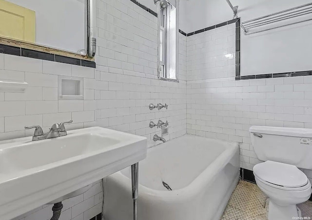 bathroom featuring tile patterned floors, tasteful backsplash, tile walls, and toilet