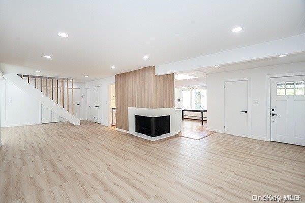 unfurnished living room with light hardwood / wood-style floors