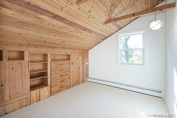 bonus room featuring carpet floors, wood walls, a baseboard radiator, lofted ceiling with beams, and wood ceiling