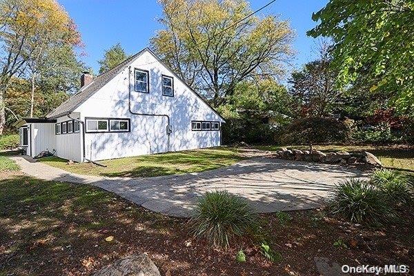 view of side of property with a lawn