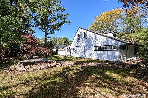 view of side of home with a yard