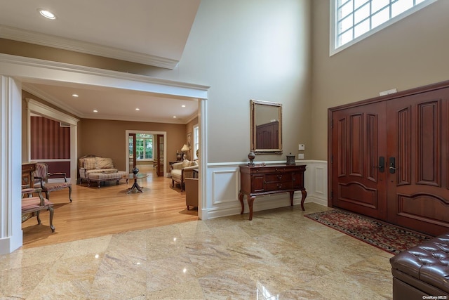 entryway featuring light hardwood / wood-style flooring and ornamental molding