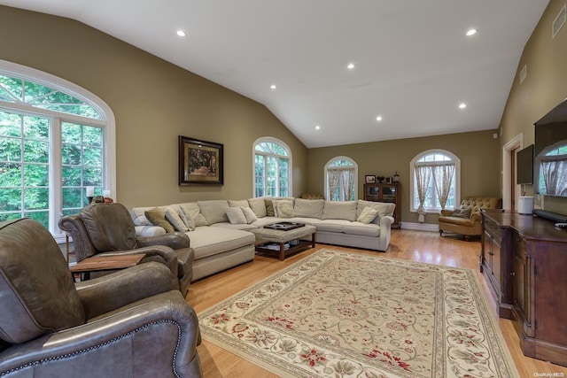 living room with vaulted ceiling and light hardwood / wood-style flooring