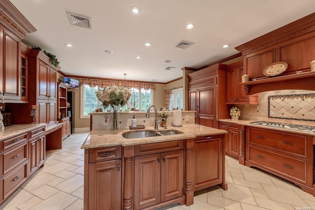 kitchen featuring sink, hanging light fixtures, stainless steel gas cooktop, backsplash, and crown molding