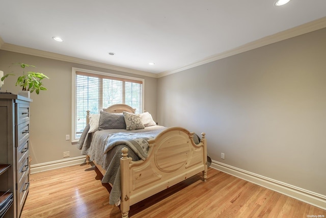 bedroom with crown molding and light wood-type flooring