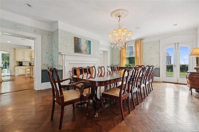 dining space with parquet flooring and an inviting chandelier