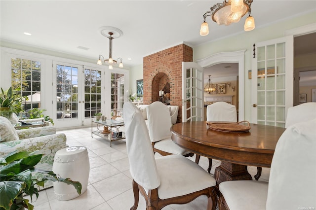 dining area with french doors, light tile patterned floors, and ornamental molding