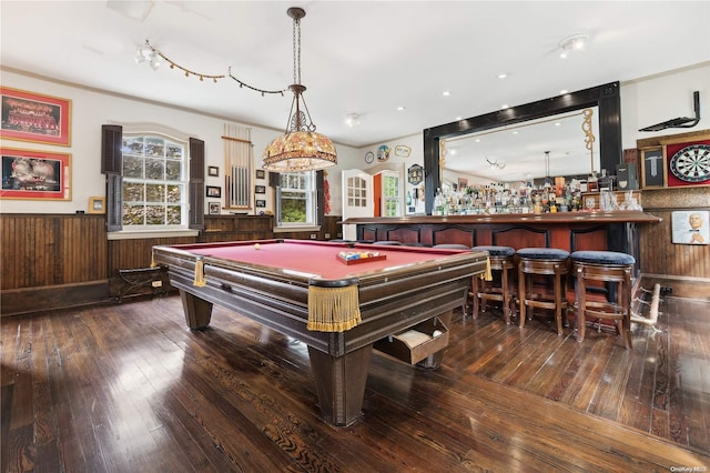 game room featuring hardwood / wood-style floors, indoor bar, wooden walls, and pool table