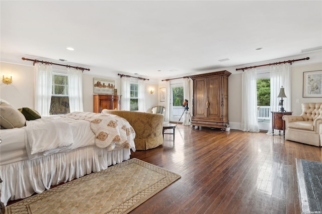 bedroom featuring crown molding and dark wood-type flooring