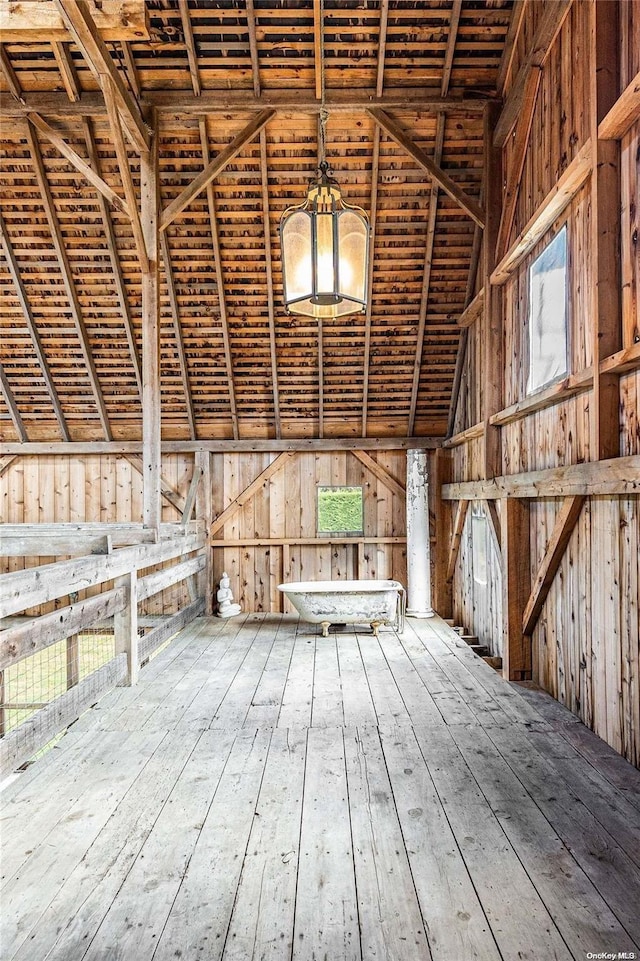 misc room featuring hardwood / wood-style flooring and vaulted ceiling