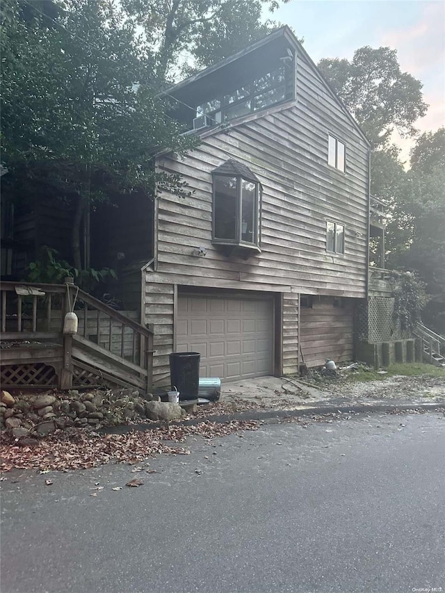 view of side of home with a garage