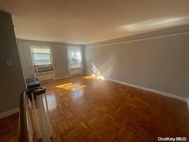 empty room with dark parquet flooring