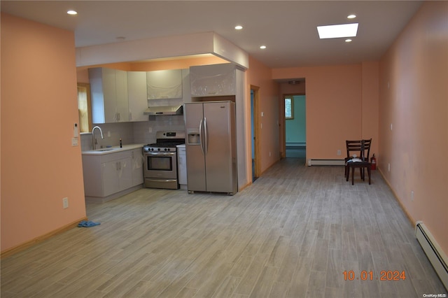 kitchen with baseboard heating, light hardwood / wood-style flooring, stainless steel appliances, and sink