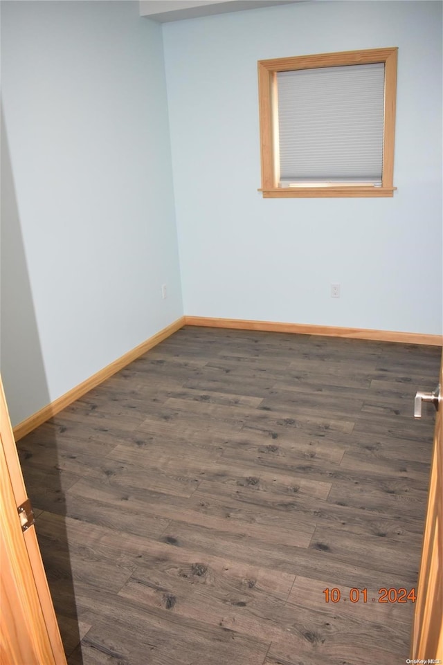 spare room featuring dark hardwood / wood-style flooring