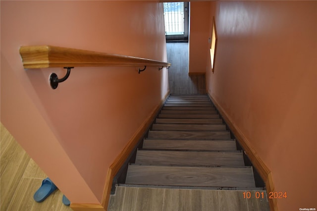 staircase with wood-type flooring