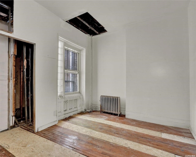 475 W 140th St, New York Manhattan, NY 10031 - empty room with radiator and wood-type flooring