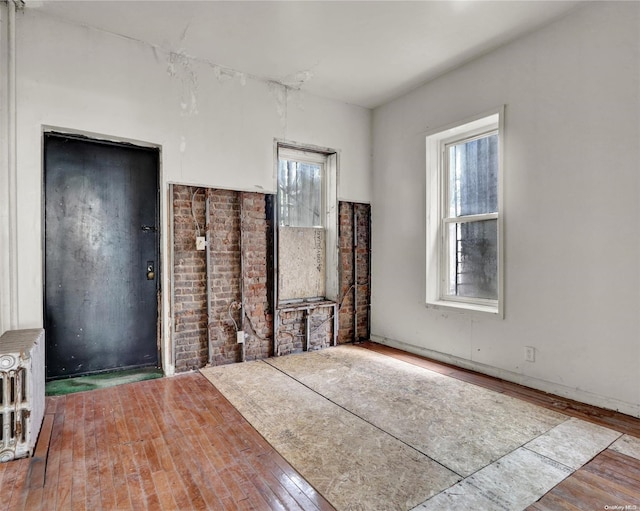 475 W 140th St, New York Manhattan, NY 10031 - unfurnished living room with radiator and wood-type flooring