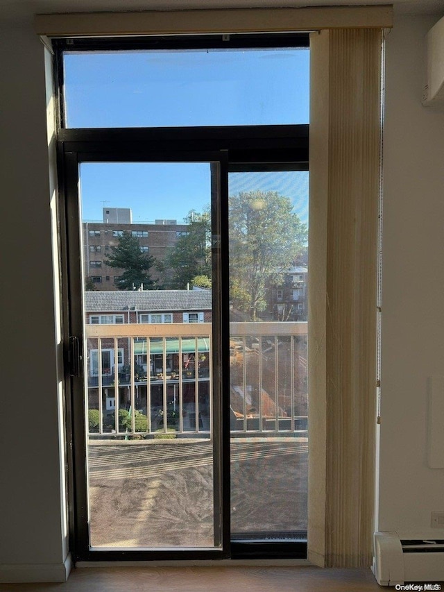 doorway featuring plenty of natural light and a baseboard radiator