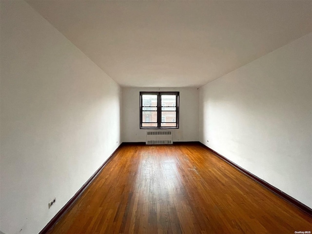37-27 86th St Unit 4A, Jackson Heights, NY 11372 - unfurnished room featuring radiator heating unit and dark wood finished floors