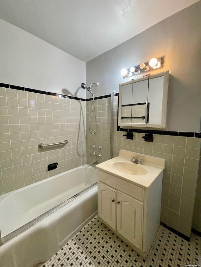 37-27 86th St Unit 4A, Jackson Heights, NY 11372 - bathroom featuring tile walls,  shower combination, vanity, and tile patterned floors