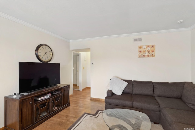 living room featuring light wood-type flooring and ornamental molding