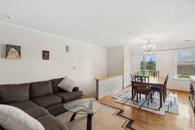 interior space featuring an inviting chandelier, light hardwood / wood-style floors, and ornamental molding