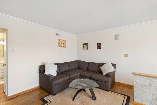 living room featuring wood-type flooring and crown molding