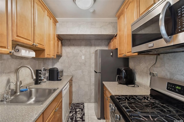 kitchen featuring sink, decorative backsplash, ornamental molding, light tile patterned floors, and stainless steel appliances