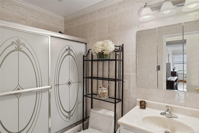 bathroom with toilet, an enclosed shower, tile walls, and ornamental molding