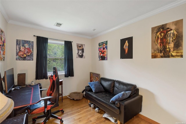 office space featuring light wood-type flooring and ornamental molding