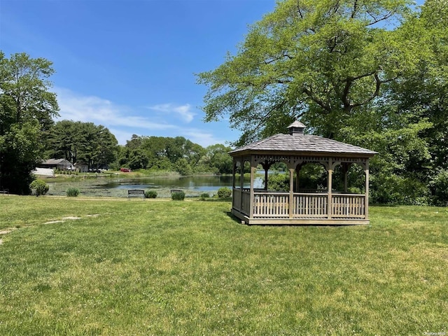 view of community with a gazebo, a water view, and a lawn