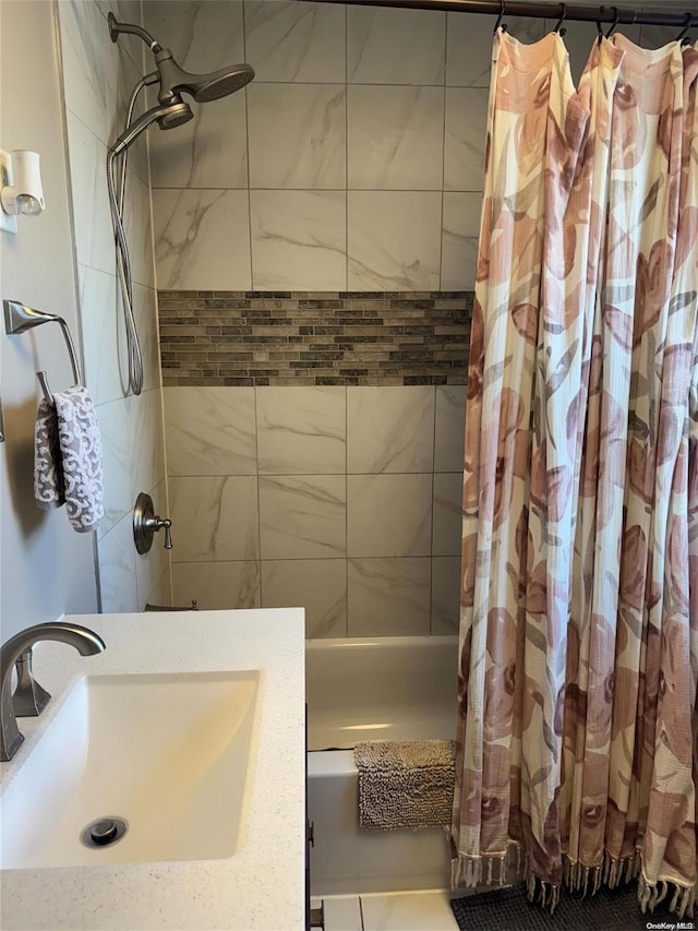 bathroom featuring shower / bath combination with curtain and sink