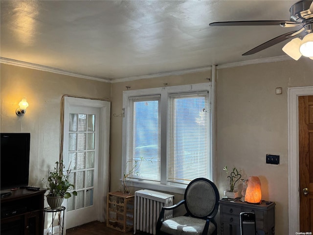 interior space with ceiling fan, plenty of natural light, ornamental molding, and radiator heating unit